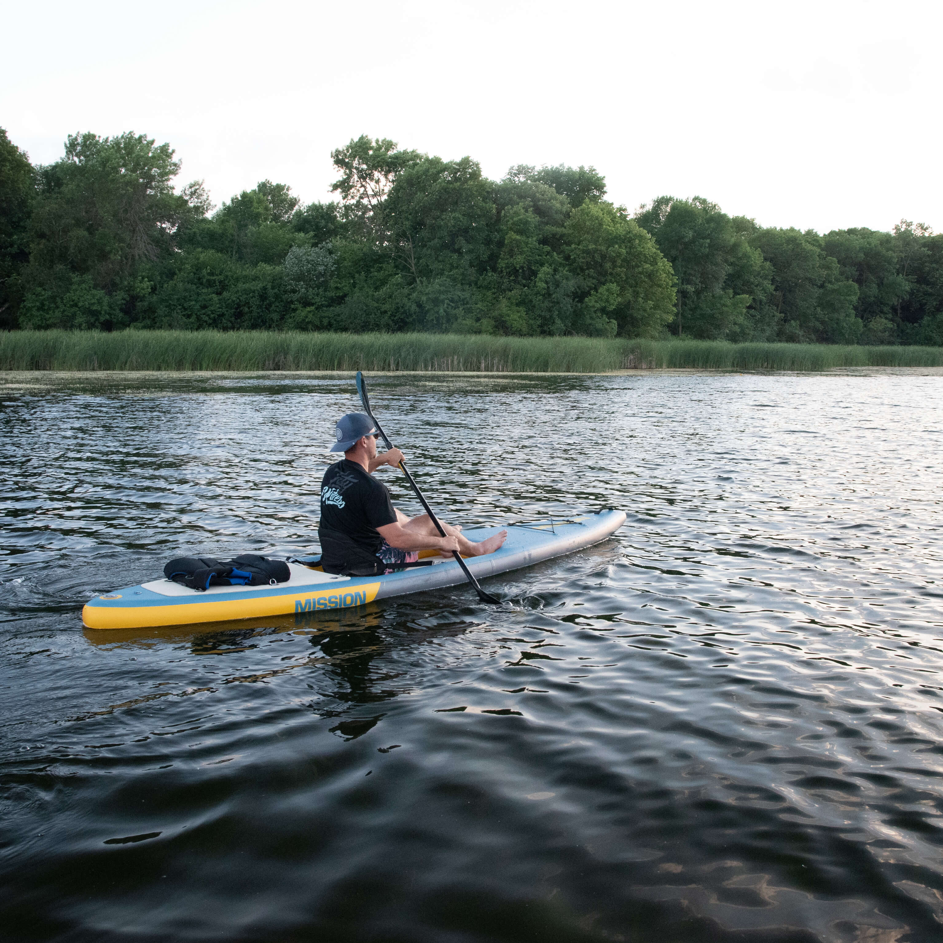 person on lake with STILLWATER Inflatable Kayak + iSUP Crossover