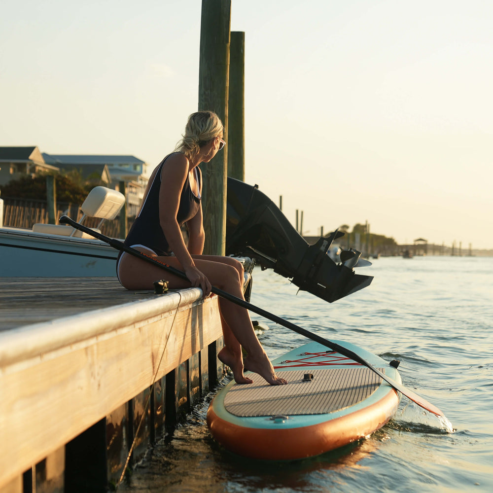 person on dock with argo isup paddle board