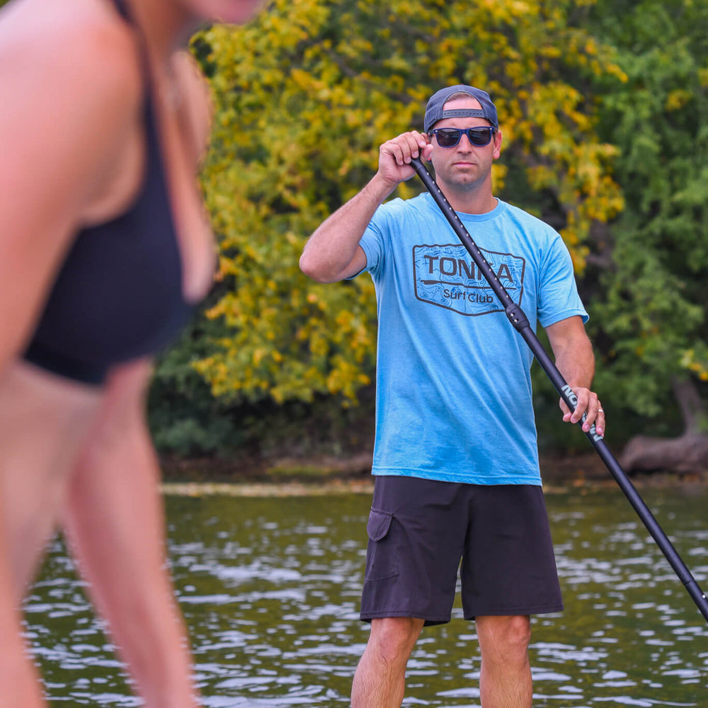 person wearing light blue tonka surf club shirt