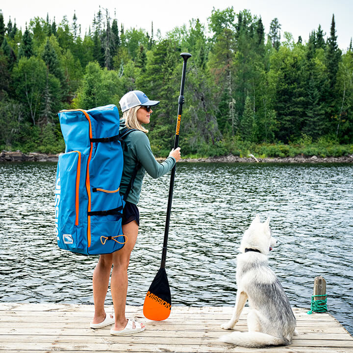 Person on standup paddleboard using the carbon fiber paddle from MISSION