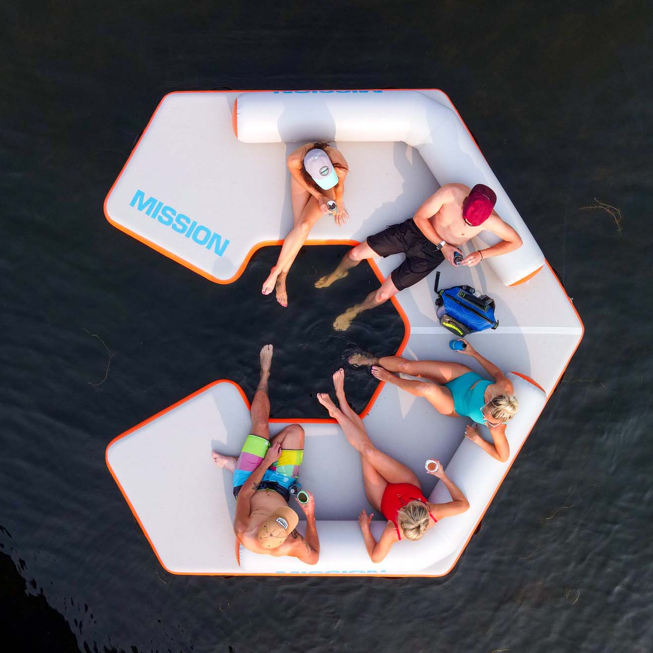 5 people on the reef lounge inflatable swim platform and lounger