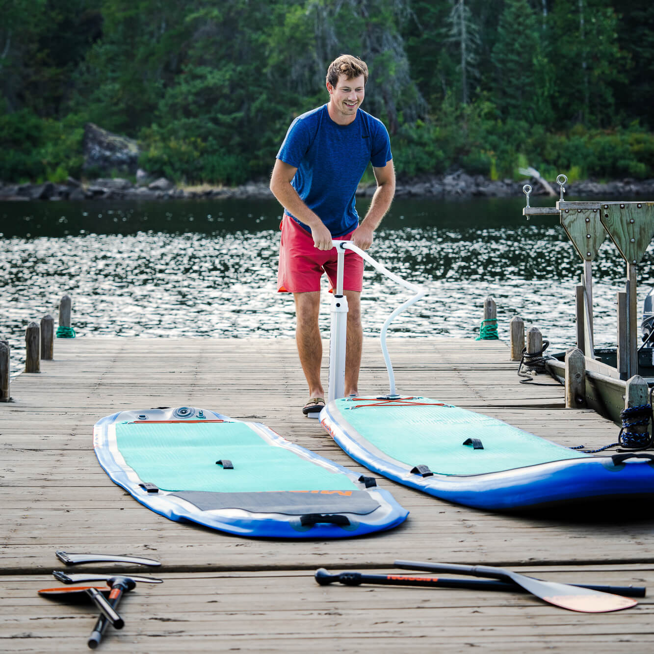 person on dock with two ZEN Inflatable SUPs