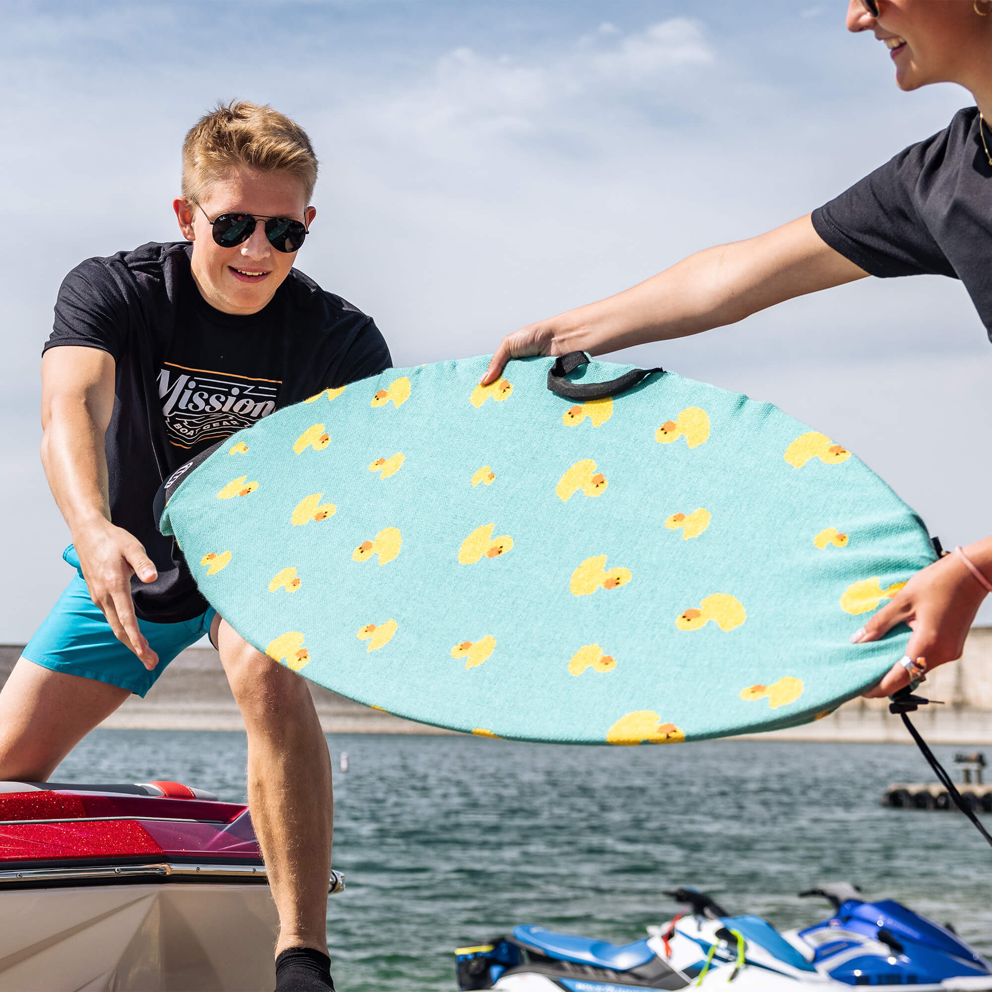 person holding board with quack board sock