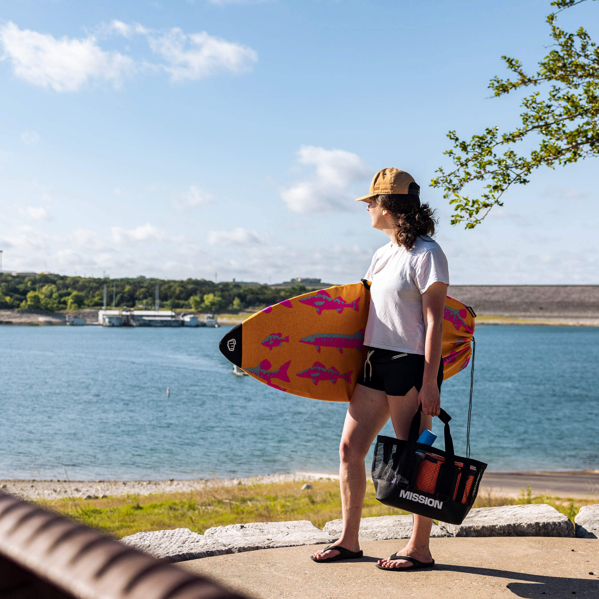 person holding mission wakesurf board with boardsock