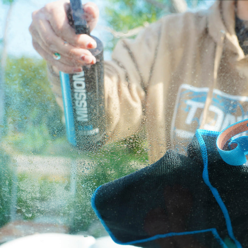 person cleaning glass with boat detailing towels