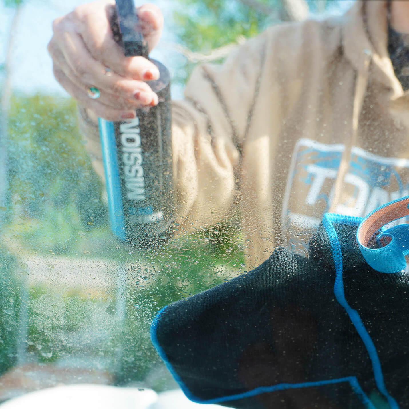 person cleaning glass with boat detailing towels