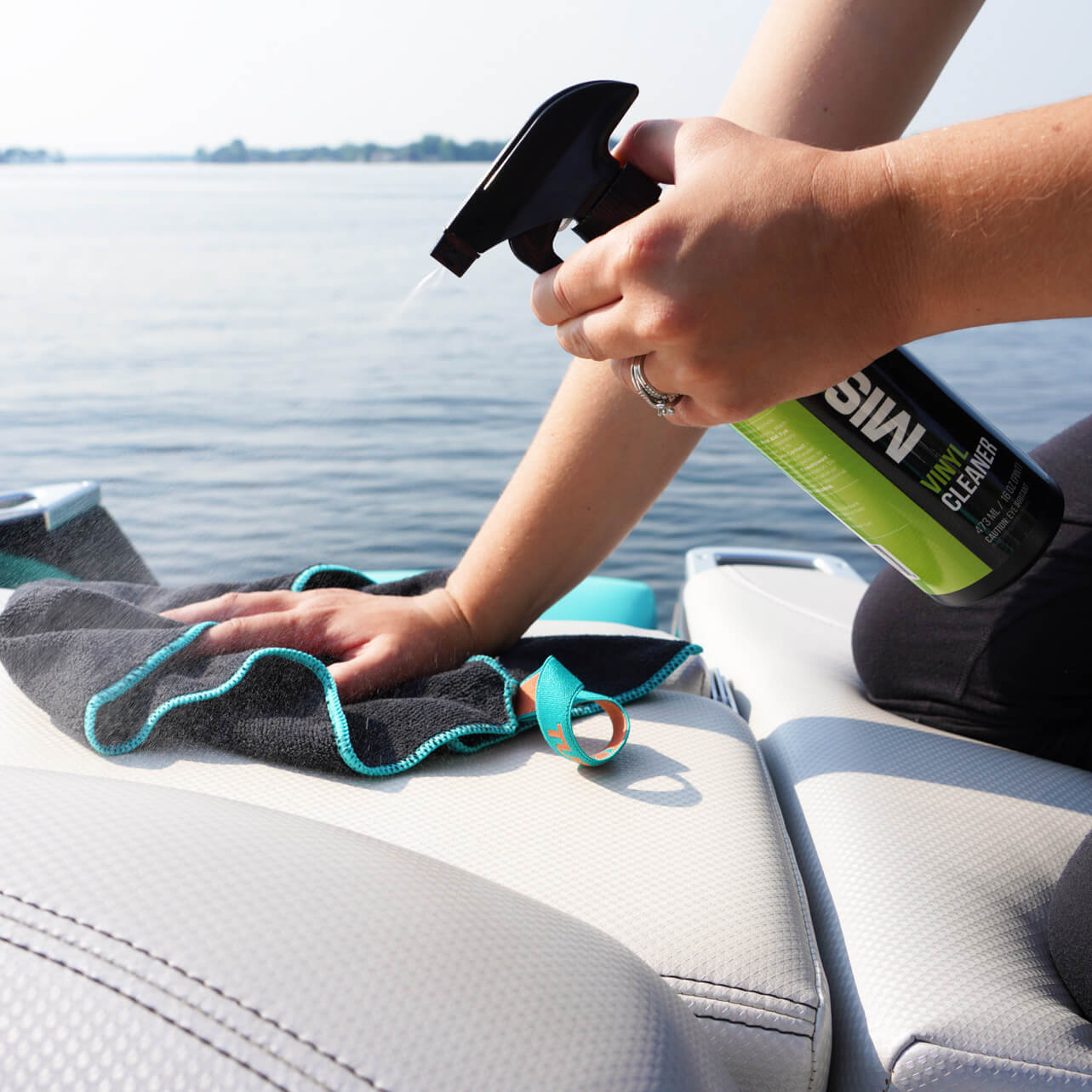 person cleaning boat with boat detailing towels