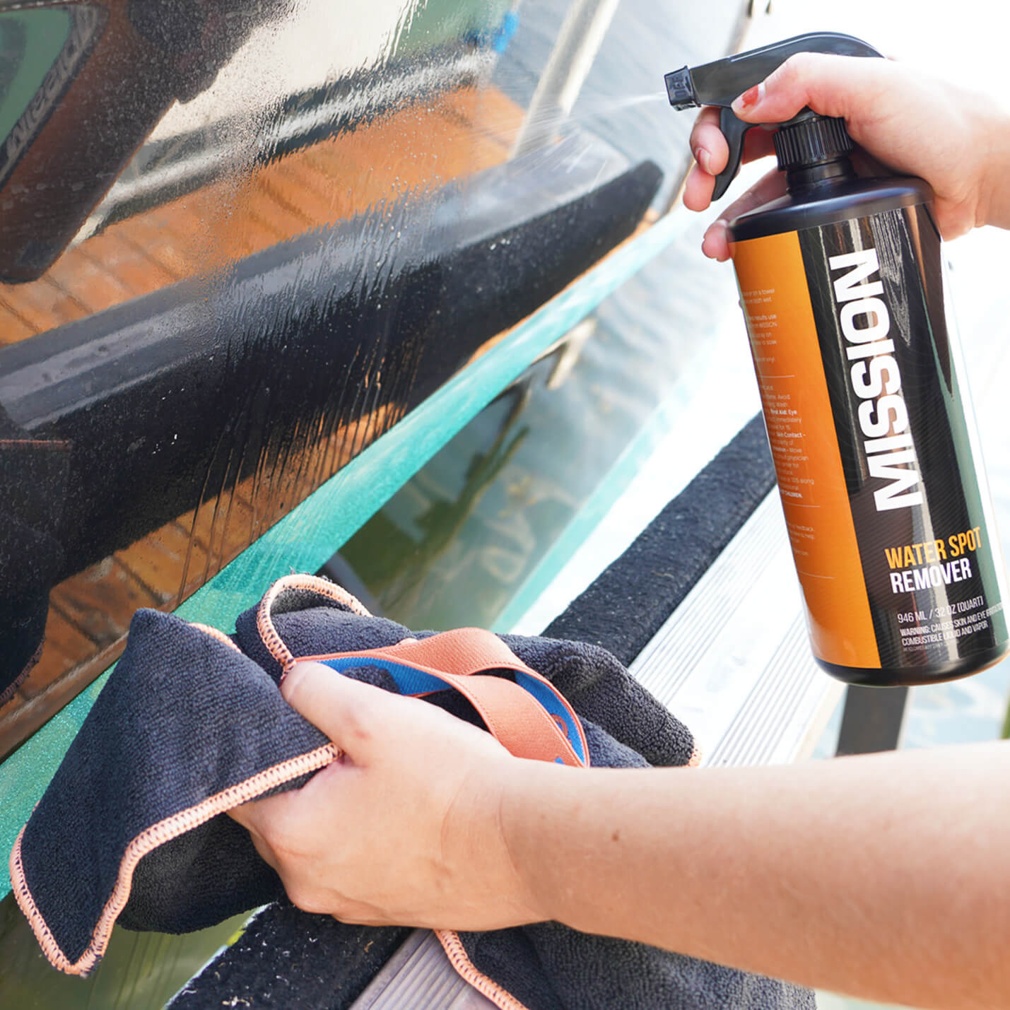 person cleaning water spots with boat detailing towels