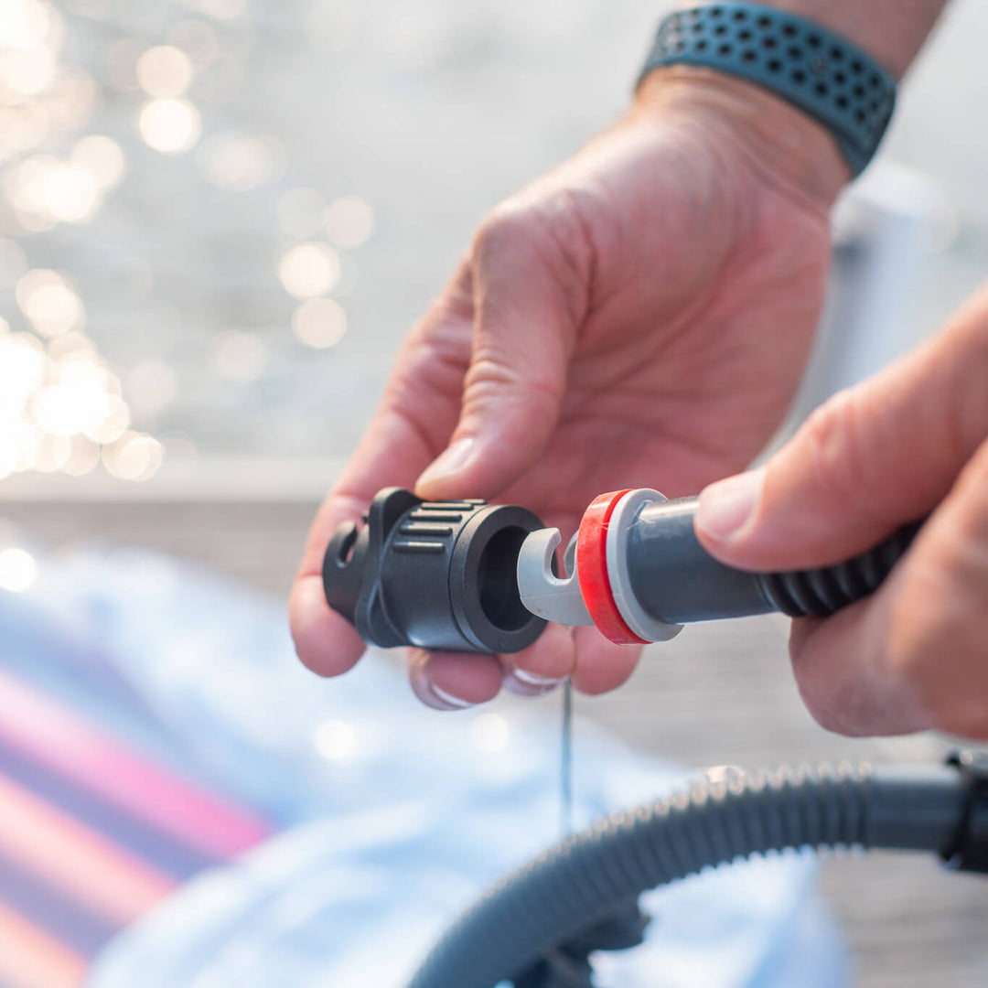 Person using air pump adapter kit to inflate mat