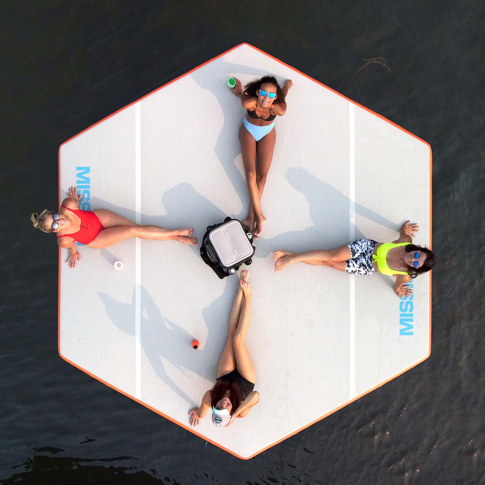 Top view of 4 people sitting on reef mat