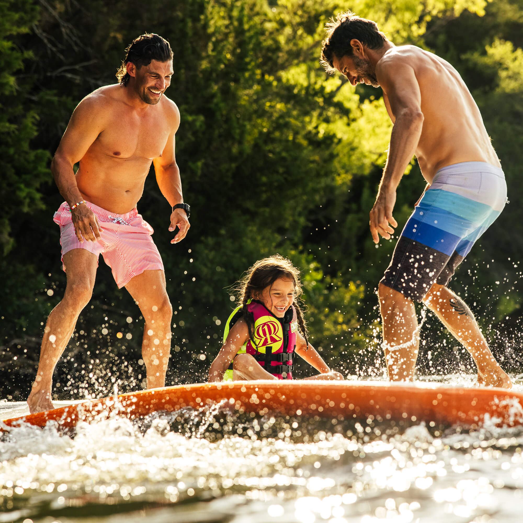 Adults and child standing on REEF mat